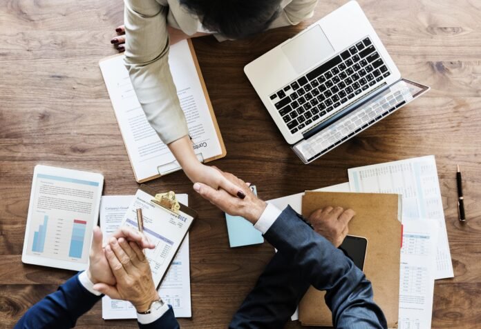 business-people-shaking-hands-together-min