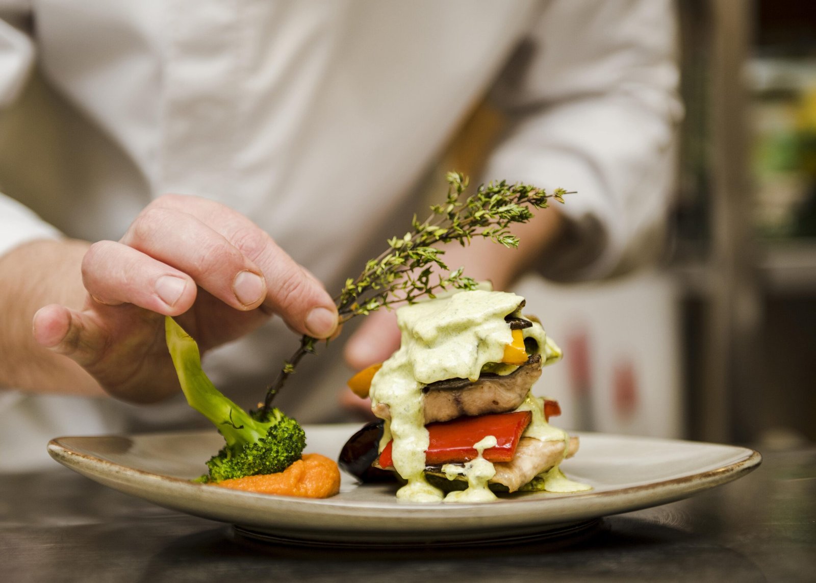 chef-placing-herb-gourmet-meal-min